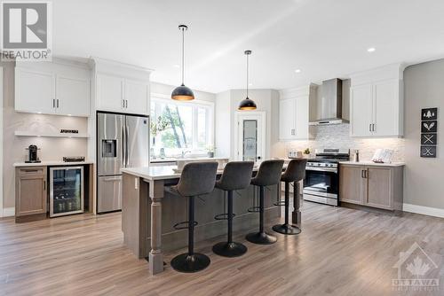 Undercabinet hard-wired lighting; custom corner pantry with decorative glass door - 1074 Barrett Chute Road, Calabogie, ON - Indoor Photo Showing Kitchen With Upgraded Kitchen