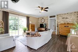 Family room with attractive stone wall - 