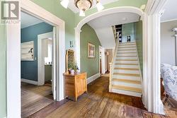 Home has central staircase with charming archway - 