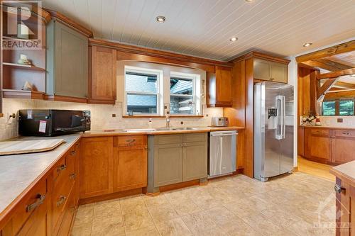 Well-designed, inviting kitchen with cherry cabinetry and pantry - 2499 Bathurst Concession 2 Road, Perth, ON - Indoor Photo Showing Kitchen With Double Sink