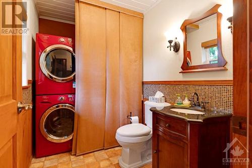 Main floor combined laundry and powder room - 2499 Bathurst Concession 2 Road, Perth, ON - Indoor Photo Showing Laundry Room