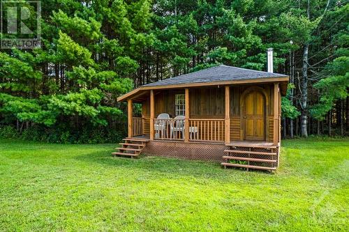 Elves, and guests, are welcomed to enchanting Bunkie that has power and woodstove - 2499 Bathurst Concession 2 Road, Perth, ON - Outdoor With Deck Patio Veranda