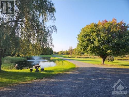 Beautifuly landscaped yard with graceful flowing fountain in 12' deep pond - 2499 Bathurst Concession 2 Road, Perth, ON - Outdoor With View