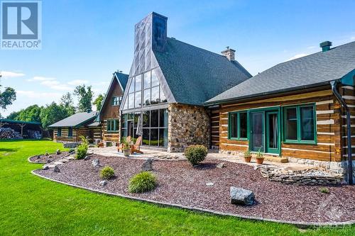 Rear view of home with its solarium's soaring glass wall - 2499 Bathurst Concession 2 Road, Perth, ON - Outdoor