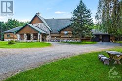 Home entrance is impressive stone portico - 