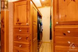 Walk-in closet with custom cabinets and drawers - 