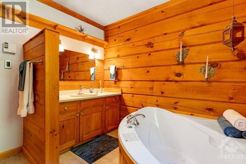 Primary suite has cheater door to bathroom with 2-person therapeutic soaker tub - 1102 Ebbs Bay Road, Carleton Place, ON - Indoor Photo Showing Bathroom