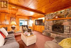 Lower level family room with 2nd Georgian Bay field-stone, wood-burning fireplace - 