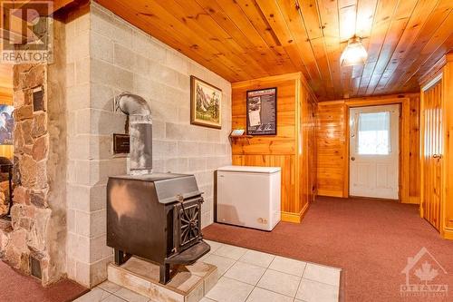 Lower level airtight woodstove and door to outside - 1102 Ebbs Bay Road, Carleton Place, ON - Indoor