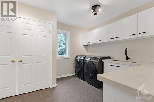 Large laundry room window, sink and lots of storage space - 5525 Pettapiece Crescent, Manotick, ON - Indoor Photo Showing Laundry Room