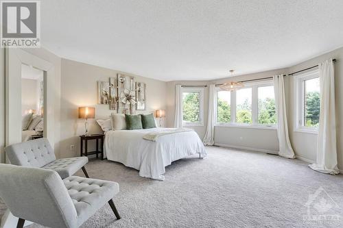 Palatial primary suite with wall of windows - 5525 Pettapiece Crescent, Manotick, ON - Indoor Photo Showing Bedroom