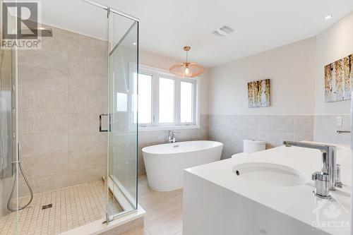 Primary suit 5-pc ensuite; two-sink vanity, glass shower spa spray. Toilet has built-in bidet - 5525 Pettapiece Crescent, Manotick, ON - Indoor Photo Showing Bathroom