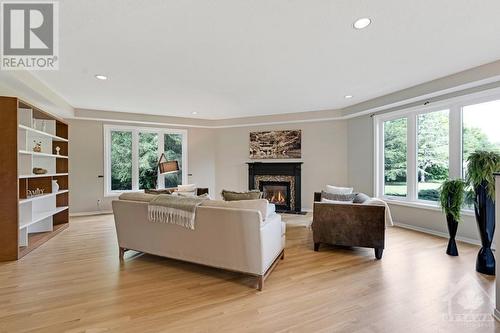 Relaxing family room with natural gas fireplace - 5525 Pettapiece Crescent, Manotick, ON - Indoor Photo Showing Living Room With Fireplace