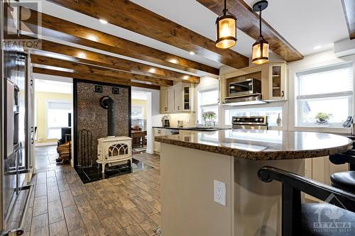 Jotul woodstove set against ceramic wall - 2344 Mclachlin Road, Beckwith (910 - Beckwith Twp), ON - Indoor Photo Showing Kitchen