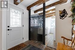 Inviting foyer porcelain floor that extends into attached laundry room - 