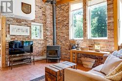 Family room's accent antiqued brick wall and Jotul woodstove - 