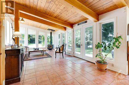 Great Room combined living area and sunroom, both areas wrapped in windows and have woodstove - 150 Dewolfe Street, Ottawa, ON -  Photo Showing Other Room