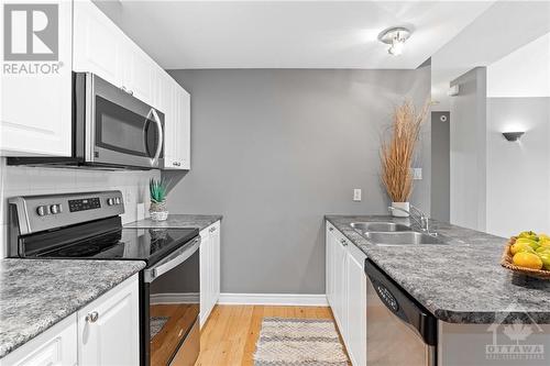 Tons of counter space and storage cabinets. - 231 Crestway Drive Unit#J, Ottawa, ON - Indoor Photo Showing Kitchen With Double Sink