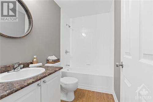 Main 4 piece bathroom includes modern mirror, vanity w/ storage underneath & bath/shower combo. - 231 Crestway Drive Unit#J, Ottawa, ON - Indoor Photo Showing Bathroom