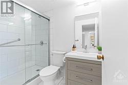 Fully renovated 3 piece bathroom w/ glass enclosed shower and modern vanity. - 