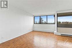 Living room w/ wall to wall windows facing south. - 