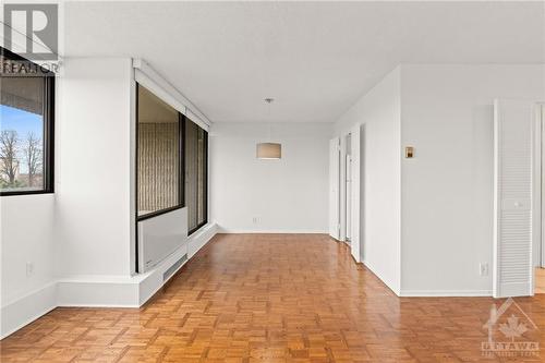 Hardwood floors throughout and professionally painted white walls and trim. - 1285 Cahill Drive Unit#507, Ottawa, ON - Indoor Photo Showing Other Room