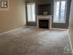 main floor family room with gas fireplace & new carpeting - 