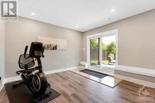 Lower level flex space with patio doors to lower patio (separate entrance for in-law suite) - 11 New Haven Gate, Westport, ON - Indoor Photo Showing Gym Room