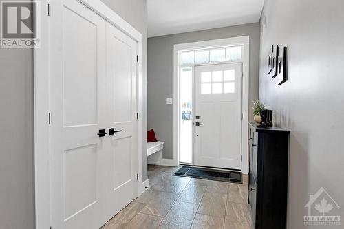 Inviting front foyer has closet, built-in bench and retractable screen on door - 11 New Haven Gate, Westport, ON - Indoor Photo Showing Other Room