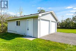 Oversized detached 2-car garage with door to yard - 