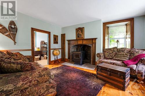 Family room stone fireplace has pellet stove insert - 1731 Beckwith 7Th Line, Carleton Place, ON - Indoor Photo Showing Living Room With Fireplace