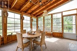 Three-season sunroom has door to tiered deck - 