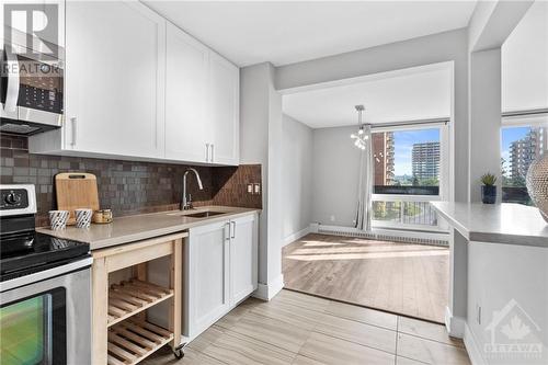 Tiled backsplash, stainless steel appliances & tons of storage space! - 1505 Baseline Road Unit#511, Ottawa, ON - Indoor Photo Showing Kitchen