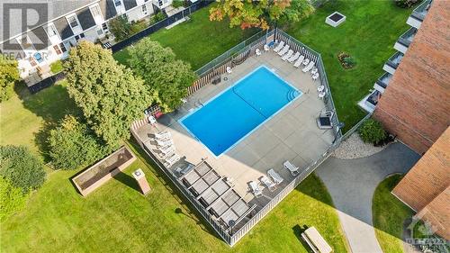 Outdoor pool w/ tons of seating to relax on hot summer days! - 1505 Baseline Road Unit#511, Ottawa, ON - Outdoor With In Ground Pool With View