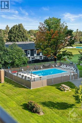 View of the outdoor pool from your own personal balcony. - 1505 Baseline Road Unit#511, Ottawa, ON - Outdoor