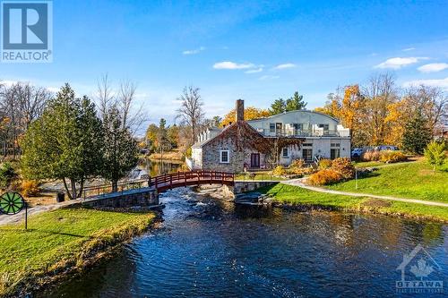 Prestigious townhome in desirable 'Mill On The Park', on Tay River beside park, in the town of Perth - 5B Lewis Street, Perth, ON - Outdoor With Body Of Water