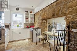 Kitchen Corian countertop, under counter lighting, silgranit sink and windows overlooking river - 