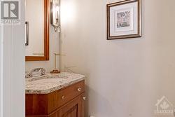 Main floor powder room granite vanity and honeycomb ceramic floor - 