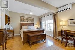 Third floor primary suite sanctuary overlooks river and park; garden door to large balcony - 