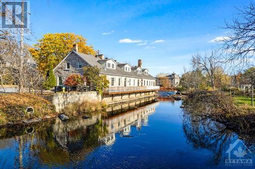 Coveted, one-of-a kind,  'Mill On The Park' - 5B Lewis Street, Perth, ON - Outdoor With Body Of Water