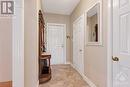 This luxurious townhome has welcoming foyer featuring walk-in closet and honeycomb ceramic floors - 5B Lewis Street, Perth, ON  - Indoor Photo Showing Other Room 