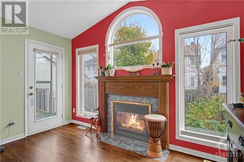 The family room features a cozy fireplace, creating a warm and inviting atmosphere that's perfect for relaxing on chilly evenings. With ample space for comfortable seating and natural light filter - 17 Coleridge Street, Ottawa, ON - Indoor Photo Showing Living Room With Fireplace