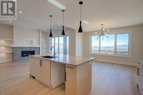 1018 Emslie Street, Kelowna, BC - Indoor Photo Showing Kitchen With Fireplace With Double Sink