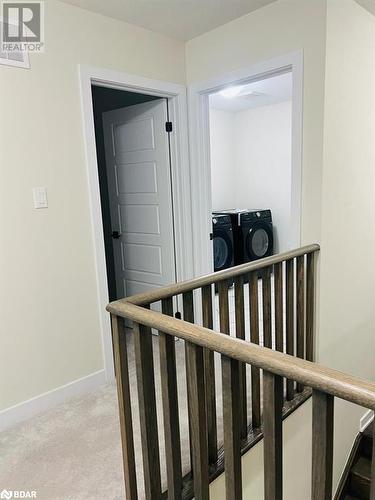 Hall with washing machine and dryer and carpet floors - 113 Stern Drive, Welland, ON - Indoor Photo Showing Other Room