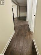 Hallway featuring dark hardwood / wood-style floors - 