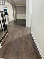 Hall featuring dark wood-type flooring - 