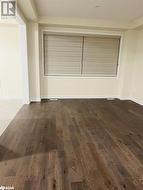 Empty room with dark hardwood / wood-style flooring - 