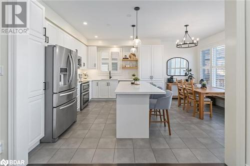 Kitchen with a kitchen breakfast bar, sink, appliances with stainless steel finishes, a kitchen island, and white cabinetry - 19 Mugford Crescent, Brampton, ON - Indoor Photo Showing Kitchen With Upgraded Kitchen