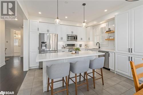 Kitchen with stainless steel appliances, sink, light hardwood / wood-style flooring, a center island, and white cabinetry - 19 Mugford Crescent, Brampton, ON - Indoor Photo Showing Kitchen With Upgraded Kitchen