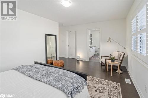 Bedroom featuring ensuite bath and dark wood-type flooring - 19 Mugford Crescent, Brampton, ON - Indoor Photo Showing Bedroom